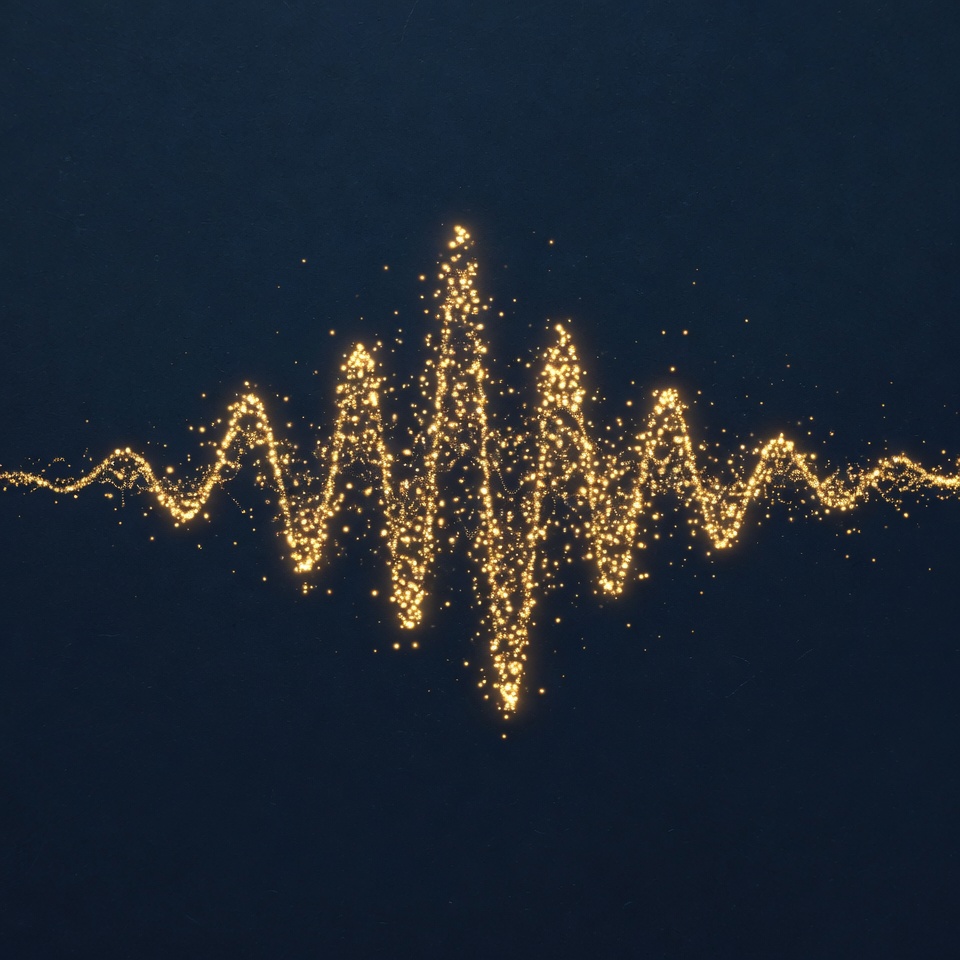 Sound wave traced in gold particles on navy